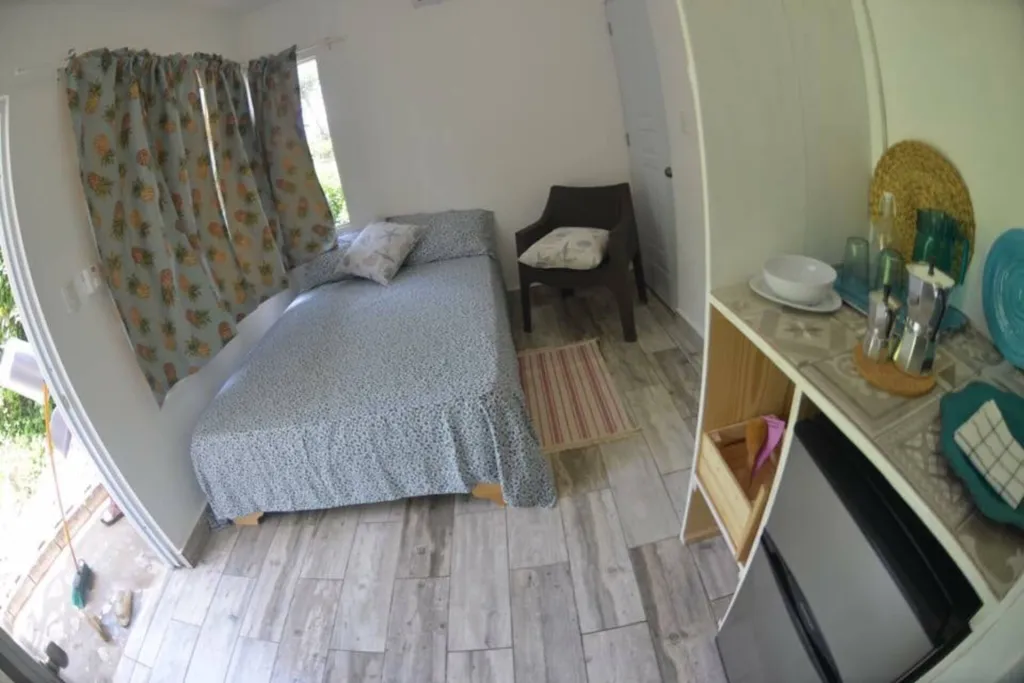 Single bedroom with pineapple curtains
