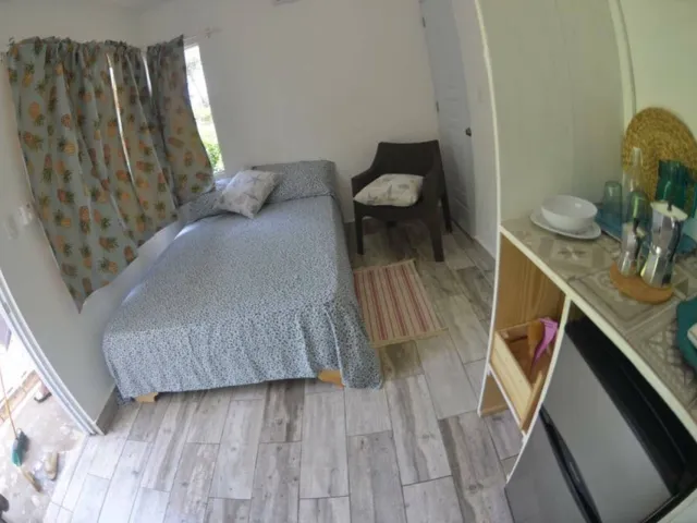 Single bedroom with pineapple curtains