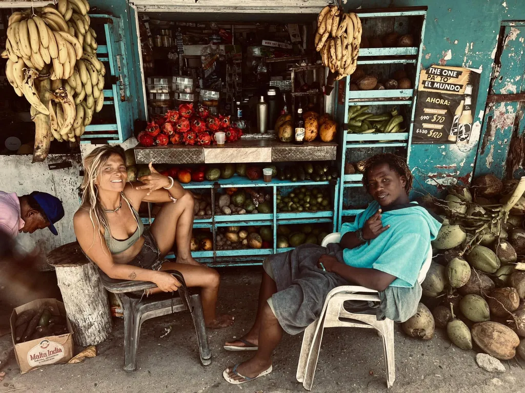 Samuela at a fruit and vegetable stand in the neighbourhood