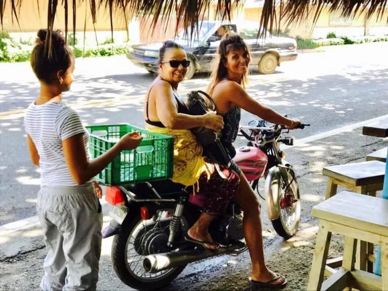 Neighbours and kids by a moto on the street