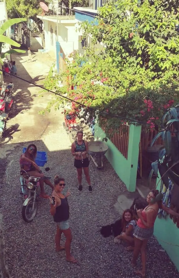 The lane outside, seen from above, with neighbours chatting
