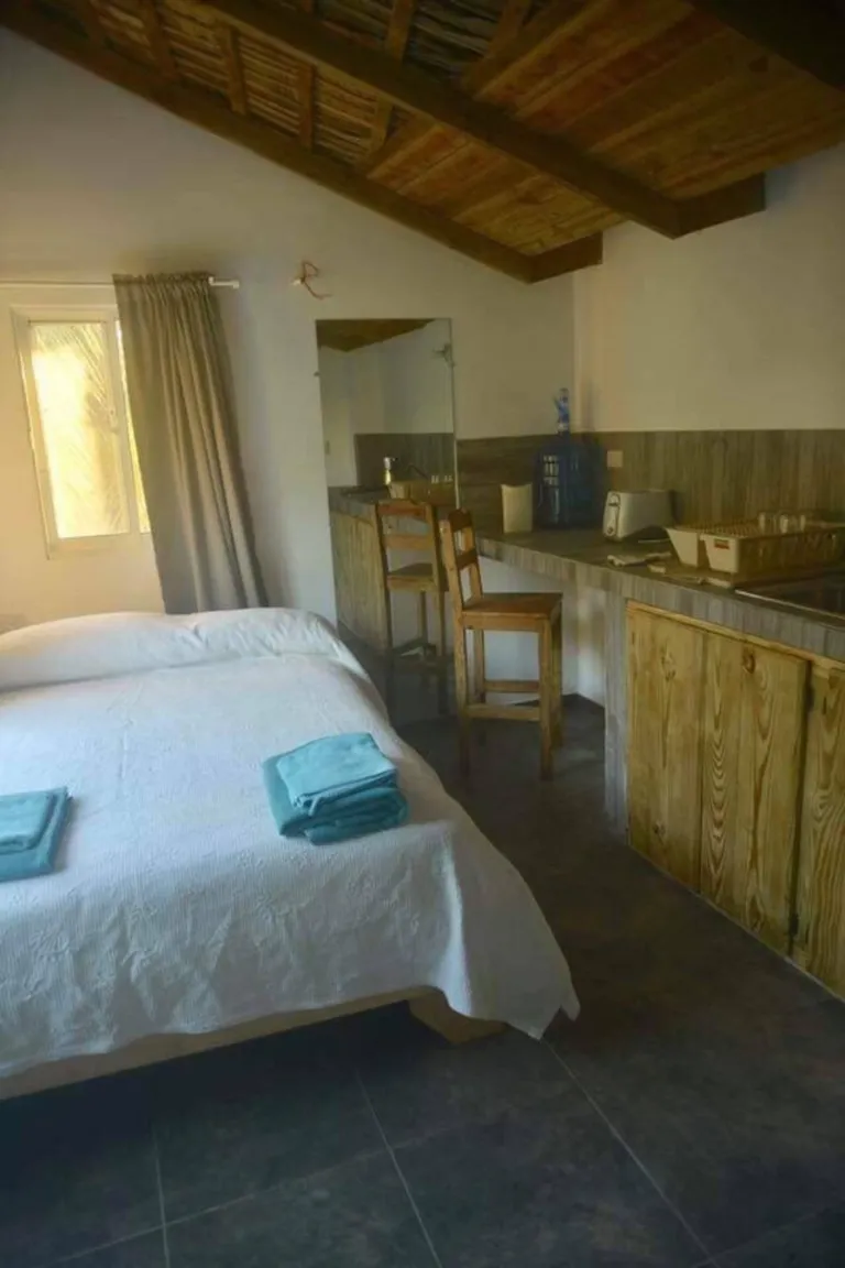 Bed and kitchenette in Brisa Loft